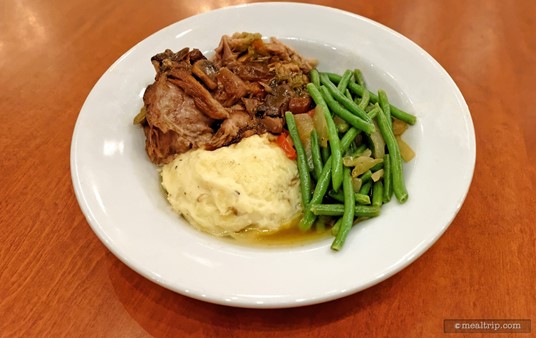 It may not win any "most beautifully plated" awards (or most actually "French"), but the lunch version of Be Our Guest's "Braised Pork - Coq Au Vin Style" is really good eats.
