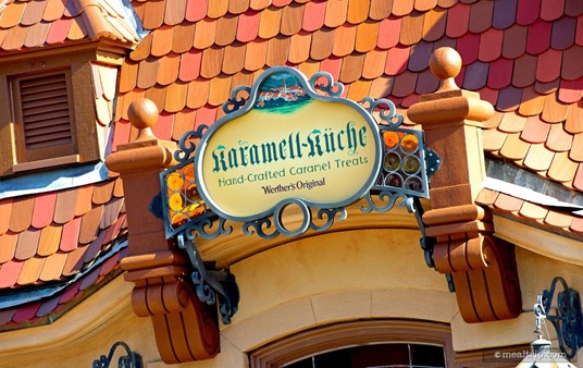 Karamell Kuchue Hand Crafted Caramel Treats sign, above the entrance facing World Showcase Lagoon.