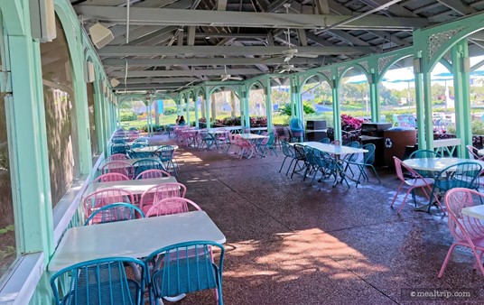A fully covered seating area wraps around both sides and behind Mango Joe's.