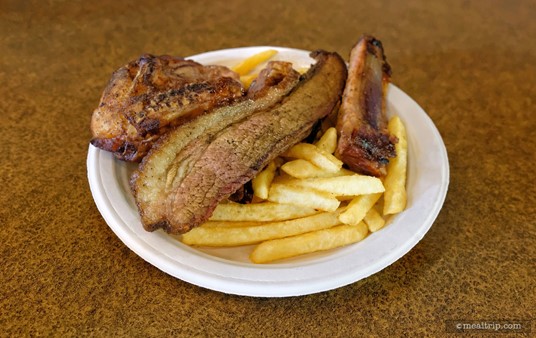The Barbecue Sampler Platter at  Voyager's Smokehouse is served with 
Fries. The "meal" plates at  Voyager's no longer include a dinner roll. 
There is BBQ sauce available in packets. (Photo 2023)