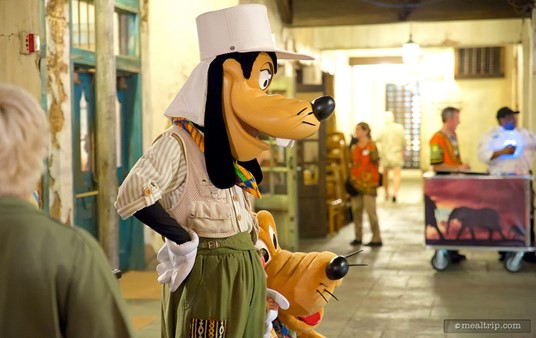 Safari Goofy at Pluto pose for pictures during the street party segment of Animal Kingdom's Harambe Nights.