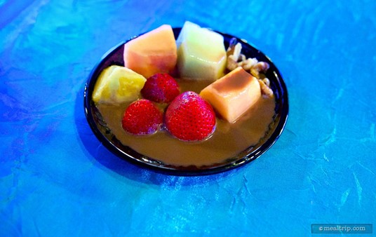 Chocolate Fondue poured over a fruit plate.
