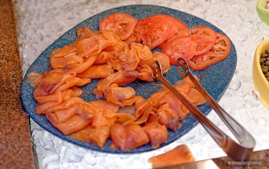 Smoked Salmon and Sliced Tomatoes are plated together. Capers, Onions and Bagels are also available.