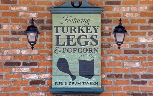 A close up of the "Turkey Leg & Popcorn" sign at the Fife & Drum.
