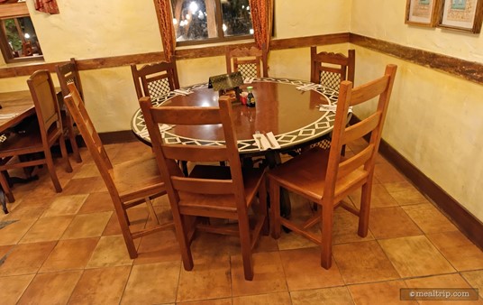 This round table for six might be a little tight for six actual people, but I could see five sitting here comfortably.