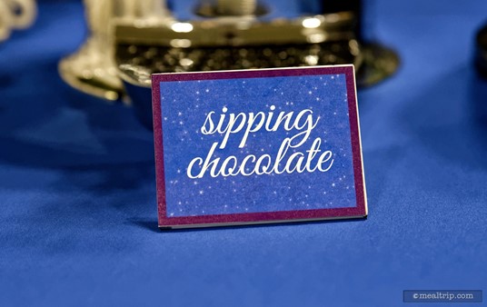A cute sipping chocolate sign.
