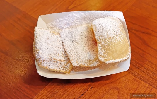 Fresh, hot beignets are available all day long from the Sassagoula Floatworks, at Disney's Port Orleans, French Quarter. You can get a three count (shown here) or a half-dozen at a time.