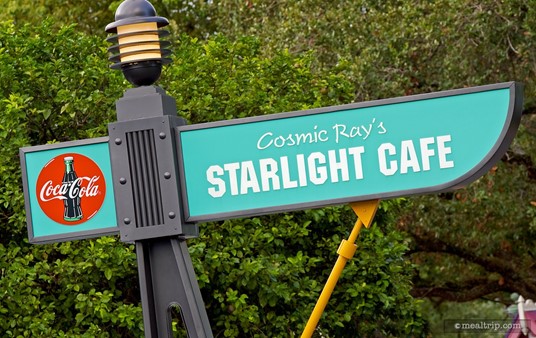 This Cosmic Ray's Starlight Cafe sign is across from the Tomorrowland Speedway and down by the Mad Tea Party attraction.