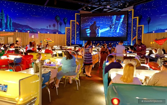 Star Wars clips are playing on the big screen as guests enjoy the Galactic Dine-In Breakfast at Hollywood Studios.