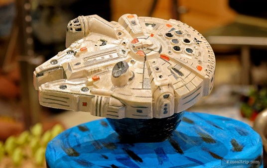 A very detailed Millennium Falcon cake topper made from chocolate is a center piece at the dessert station.
