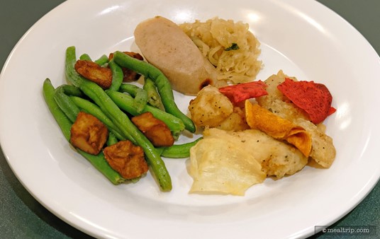 Plated Fish and Chips, Felucia Fasolaka, and Bratwurst with Sauerkraut.