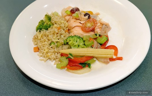 Plated Sauteed Mixed Vegetables, Fried Rice, and Salmon with Blistered Tomatoes and Cranberry Garnish.