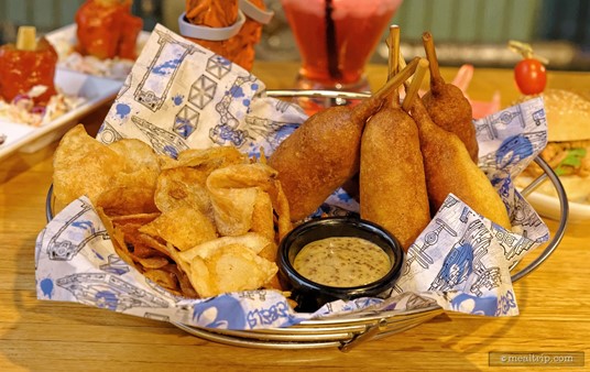 The Lightsaber Bites at the Rebel Hangar are hand-dipped and corn-battered Knockwurst sausages and served with house-made chips and honey-mustard sauce. Perfect for sharing!