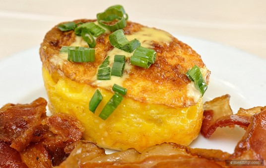 An up close photo of the Denver Frittata at the Crystal Palace. The Denver Frittata combines cage free eggs, ham, green bell peppers, onions, and cheddar cheese with some fresh cut chives.