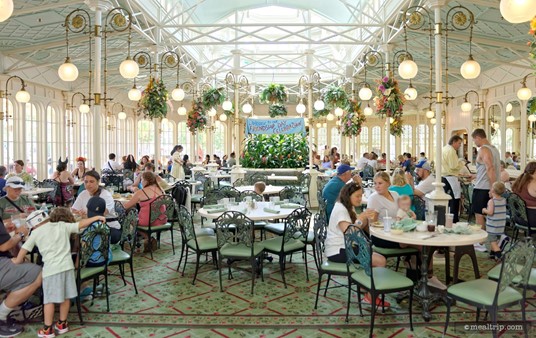 The two dining areas at the Crystal Palace are (more or less) identical. They do look a little different at various times over the course of a day. While both rooms have sun roofs – the light entering the side windows changes how much light there is in each room. This is the east side dining room at around 10:00am.
