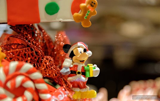 An almost microscopic gingerbread man hangs over the top of Mickey's head at the base of this dessert display.