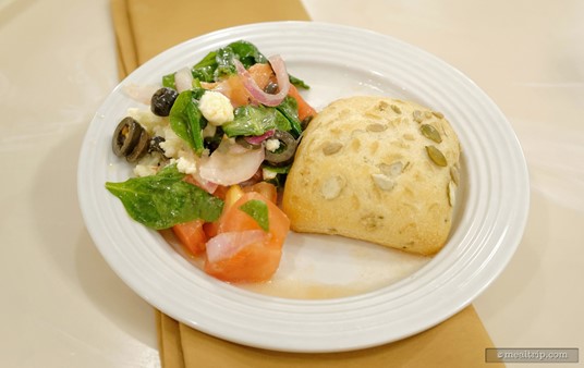 From the "prepared salads" section of the Crystal Palace buffet, this is a Greek-style Tomato Salad and a Sesame & Pumpkin Sunflower dinner roll.