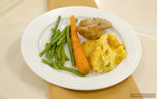 From left to right... Sautéed Green Beans, a Honey Glazed Carrot, Bangers And Cabbage, and Fire-Roasted Corn Spoon Bread.