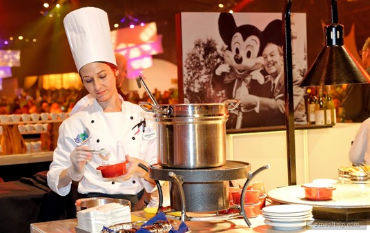 Each of the stations had photos in the center area depicting the era from which the food was from. Here, a cast member is preparing a fresh dish of Mixed Grill Chili, as Walt and Mickey look on from behind.
