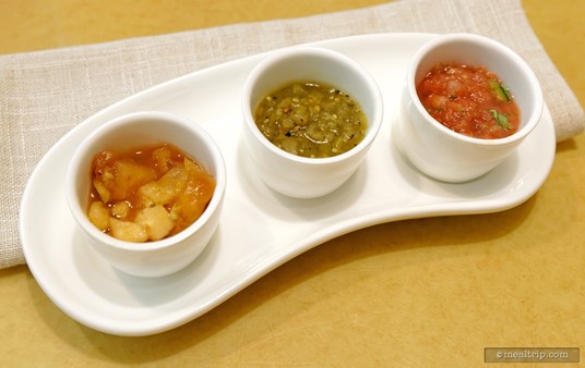 Three little cups of breakfast condiments are provided. Parts of these are said to be made with produce from the Land Greenhouses at Epcot. There is (from left to right) an Apple Chutney, a Salsa Verde, and a Salsa Fresca.