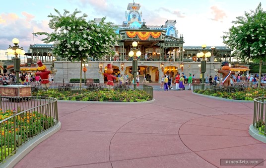 The Happy HalloWishes Premium Package parade viewing area wraps around most of the Main Street hub, including the space facing the train station... assuring that all package guests get a curb-side view of the parade.
