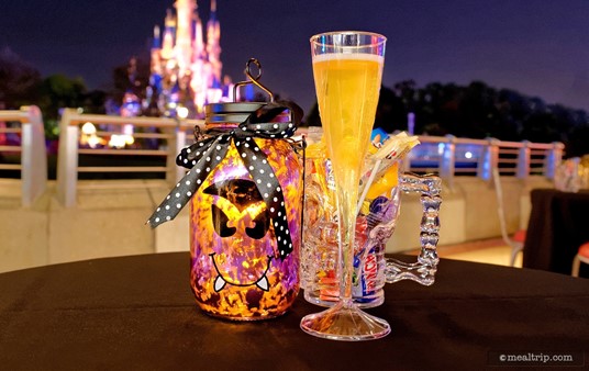 Here's a close up shot of the lantern, a flute of sparkling cider, and your very own skull cup full of candy.