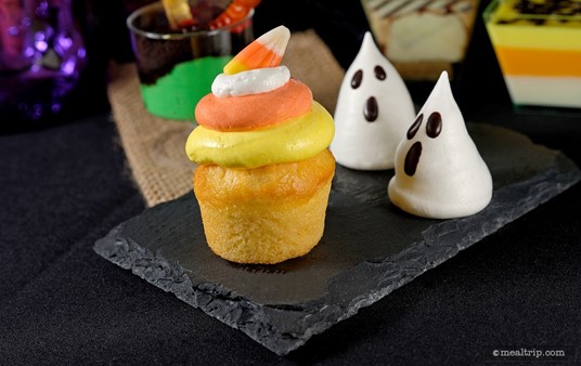 The Ghost Meringues are trying to figure out how to eat the Candy Corn Vanilla Cupcake!
