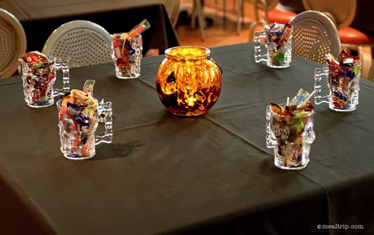 You will be escorted to your reserved table by a cast member, where you will find a skull cup full of candy for each member in your party! (There's also a cool lantern centerpiece.)