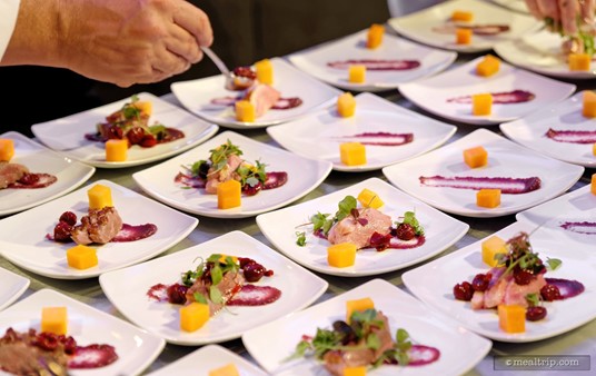 Putting the finishing touches on a Slow Cooked Duck with Balsamic and Cherry Reduction at a Party for the Senses during Epcot's Food and Wine Festival.