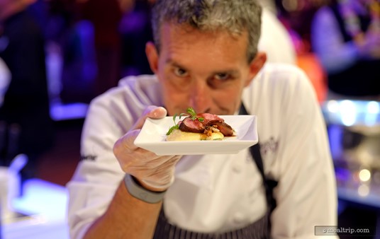 Chef Piero Premoli from "Pricci" in Atlanta, Georgia offers his Mushroom Crusted Veal Medallion with Fontina Polenta at an Epcot Food and Wine Festival Party for the Senses.