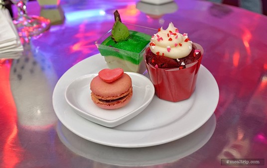 All of the desserts at Club Villain were all you care to eat! Pictured here is a Red Velvet Cupcake with Heart Sprinkles, a Red Macaron with Red Heart, and a Green Apple Mousse with Green Glitter Glaze, Leaf and Chocolate Stem.