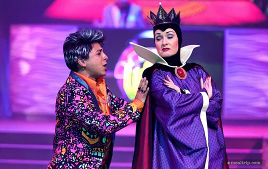 Kanzo pleads with The Evil Queen to take part in the show at Club Villain.