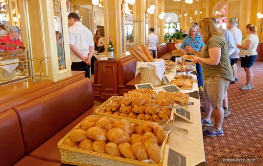 The pastry buffet-line is actually eight "normal lunch booths" that have been covered with white table linens. This area is not used for "seating" for the special Parisian Breakfast event.