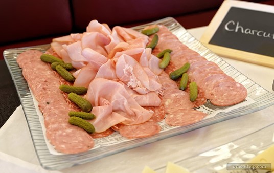 There is a Charcuterie Selection Platter that features a couple different sliced meats and pickles.