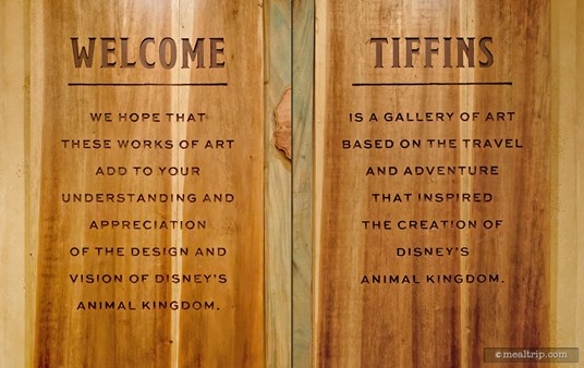 These wood panels are located on either side of the main lobby desk at Tiffins. The term "gallery of art" is used loosely. This is a great place to eat, and not a museum so much.