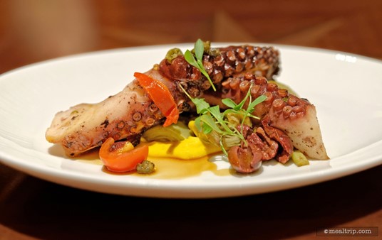 The Marinated Grilled Octopus as served with grilled artichokes, tomatoes, halved olives and a Mediterranean Aïoli.