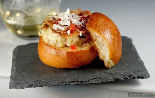 Chef Marianne's Sicilian Burger is a Pan-seared Branzino (European Seabass) Patty topped with Pecorino Cheese, Blood Orange, Raisin, Onion Jam and Dried Proscuitto on a Griddled Bun.