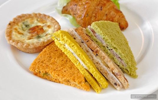 The sandwiches from The Parisian Afternoon Lunch are too cute!!! From left to right, "tomato, basil bread sandwich with basil pesto, tomato, carrot and cucumber", "curry, turmeric bread sandwich with garlic aioli and chicken", "multi grain, cranberry bread sandwich with mayonnaise, apple and turkey", and "tarragon, spinach bread sandwich with mustard tarragon butter and ham".