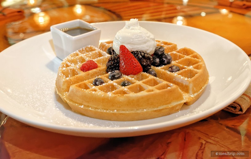 The "Safari Waffle" from Sanaa's Breakfast menu is topped with seasonal berries, a dusting of powdered sugar and chai whipped cream., Sanaa - Breakfast, Disney's Animal Kingdom Villas - Kidani Village