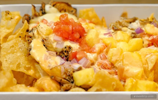 There is not a lot of pork on the pork nachos, but there is a lot of pineapple salsa, spicy mayo, and cheese.