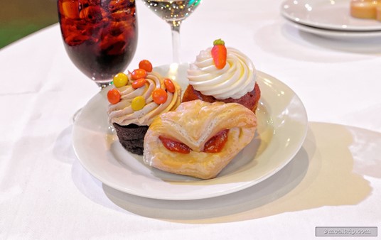 There are desserts a plenty at the New Year's Eve Dining Event. Pictured
 here are a peanut butter and chocolate cupcake along with a carrot 
cake cupcake. In the front (looking rather ominous) is a raspberry puff 
pastry.