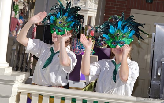 As the Liberty Square Riverboat leaves the dock, cast members wave farewell.