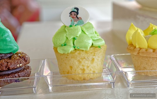 Another of the trio-of-pastries, a Yellow Sponge Cupcake topped with Green Buttercream Icing (and finished with a Tiana chocolate coin on top).
