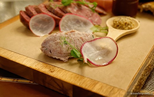 A very thin see-through radish is paired with some house-made pâté.