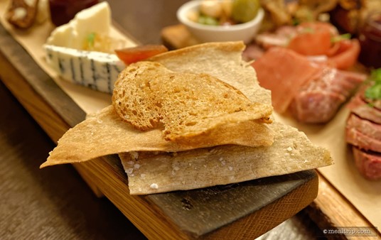 Some of the bread options that are served with the cheese board.