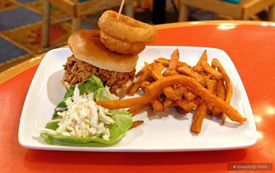 Slow-smoked Pulled Pork Sandwich                on a Brioche Roll with Onion Rings, Barbecue Sauce, and Western Slaw 
with Sweet Potato Fries. From the lunch menu at Whispering Canyon Cafe.