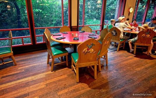 Here's a quick look at a typical table setting at Whispering Canyon Cafe. Most of the tables have a red surface and are fully lacquered (usually, with a few scratches here and there). The chairs are wooden, but the seat is moderately padded. The chairs are actually quite comfortable.