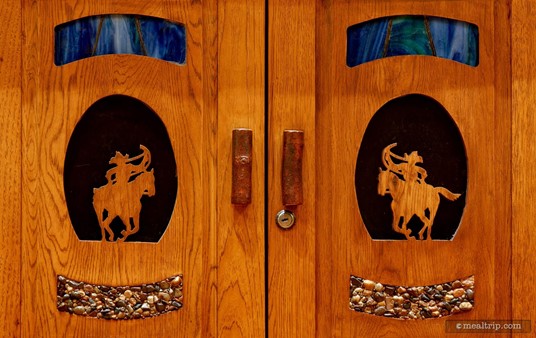 Here's a couple of cabinet doors at Whispering Canyon Cafe. It's a great mix-media piece of art, with river pebbles at the bottom, wood carving in the middle, and blue granite inlays at the top.