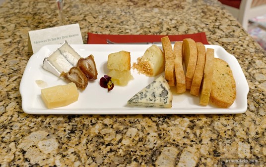 The "fourth course" cheese board contained a Red Hawk Triple Cream Brie, Humbolt Fog Goat Cheese, the (very good) Cabot Clothbound Cheddar Cheese, and a Fourme D'ambert Blue Cheese, all with accompaniments, an edible flower, and half of a House-made Lemon-Thyme Cupcake.