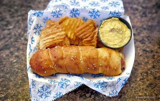 This Bratwurst Pretzel Dog is served with house-made chips, but not the mustard dipping sauce, that's an add-on.